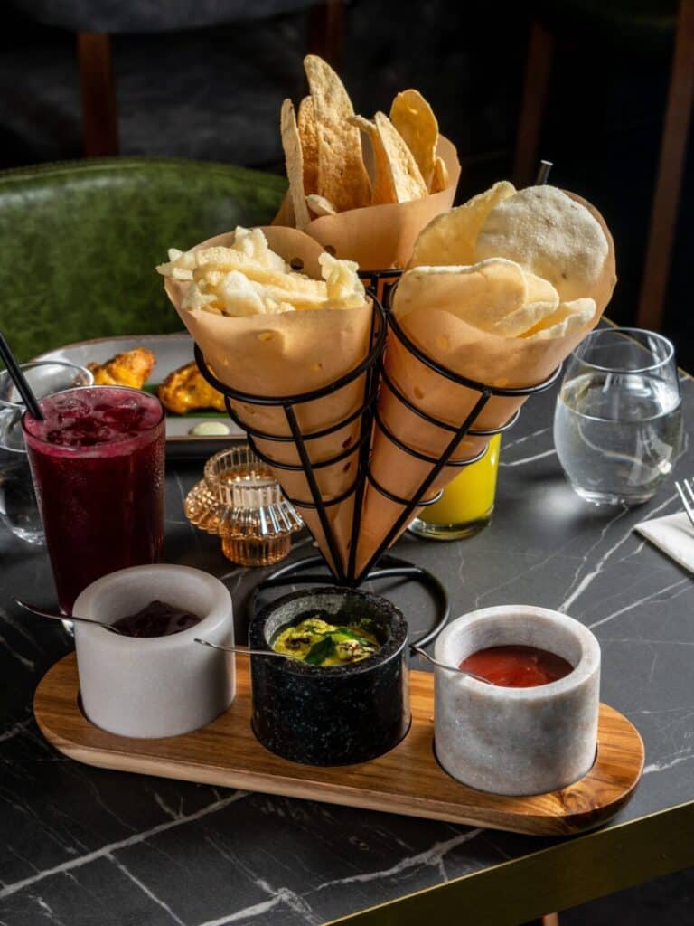 Assorted Indian breads and pastries with tea service on wooden table